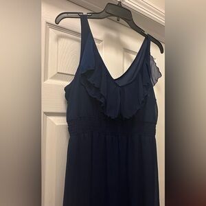 Long navy blue dress with one ruffle top and flower border.